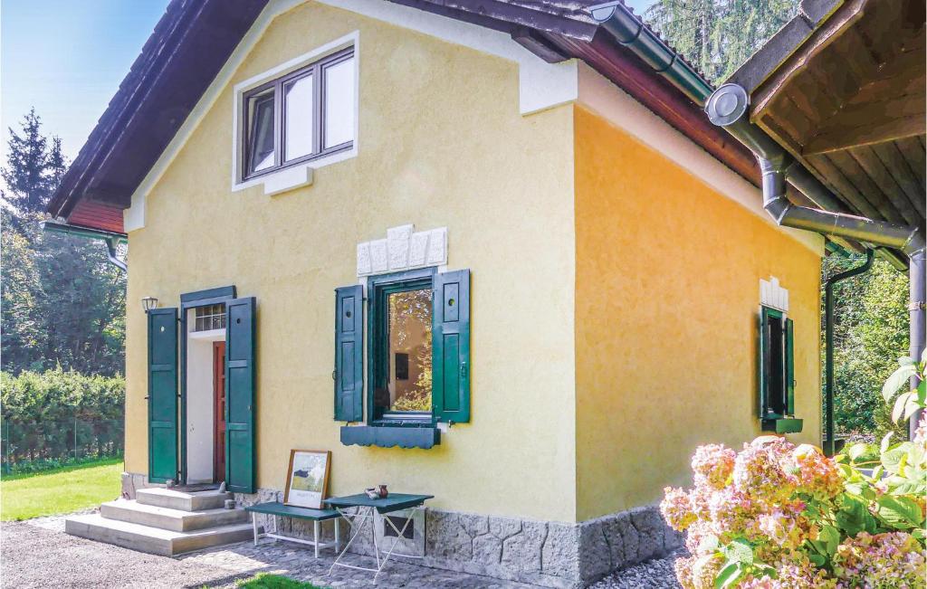 a house with blue windows and a table in front of it at Ferienhaus In St, Jakob in Maria Elend