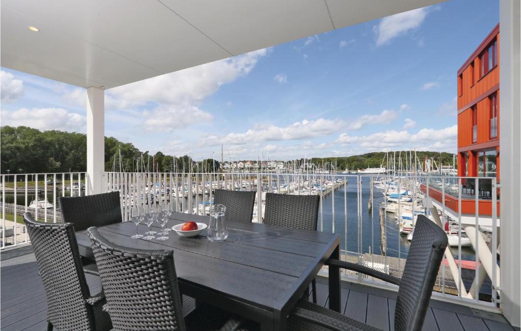 a table on a balcony with a view of a marina at Priwallpromenade 27, Whg 5 in Priwall