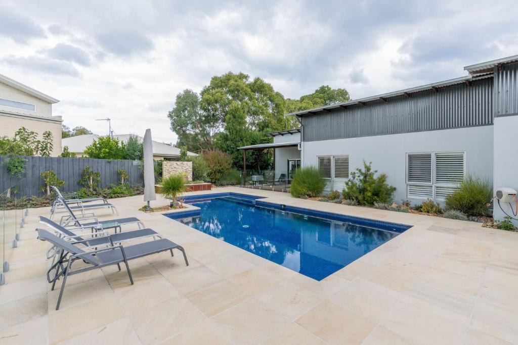 a swimming pool in the backyard of a house at Inverloch Oasis L Oasi de Invy in Inverloch