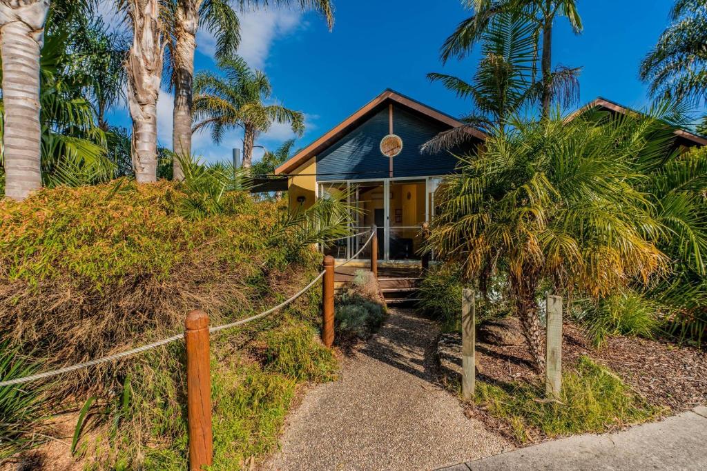 a house on a hill with palm trees at Beachy Haven at Sails close to the Beach in Inverloch