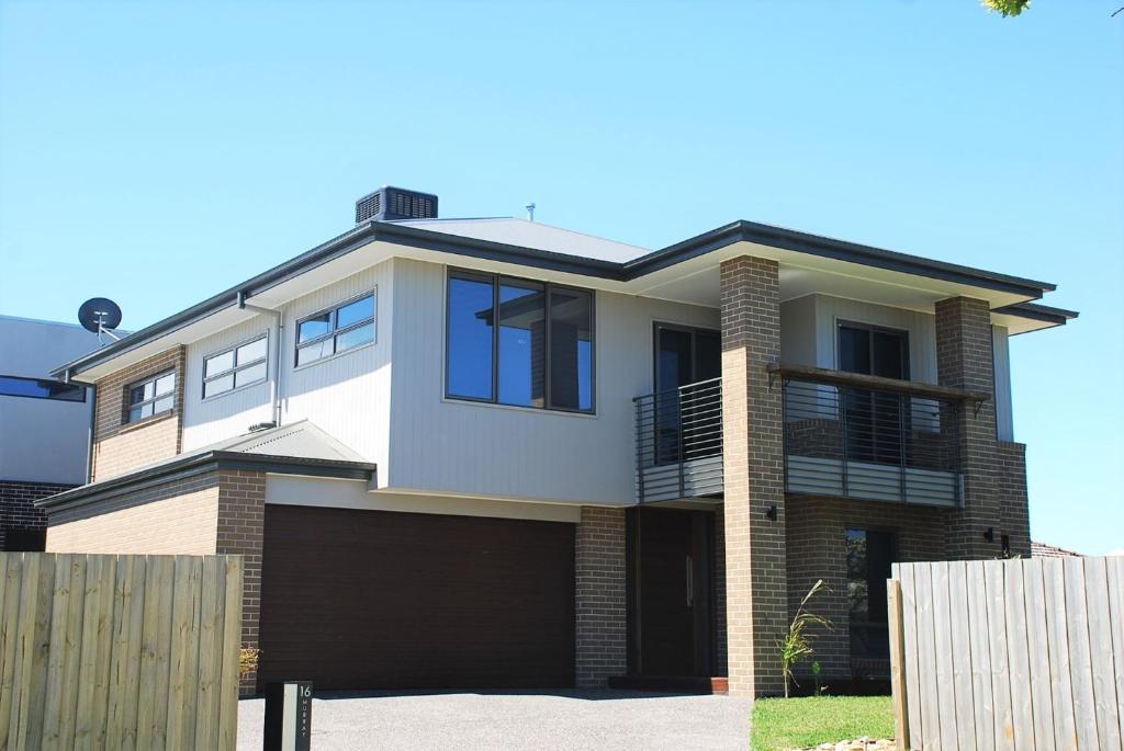 a house with a garage in front of it at Somerset on Murray in Inverloch