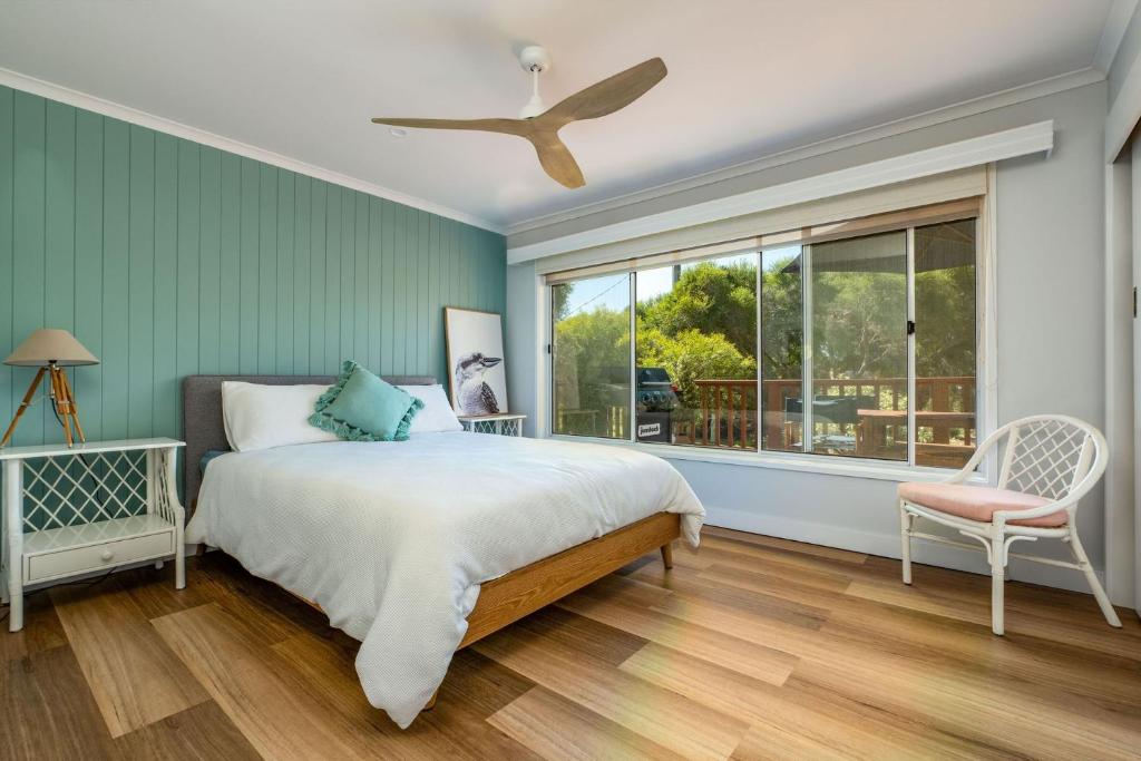 a bedroom with a bed and a large window at Hip Nautic 100 Metres to Beach in Inverloch