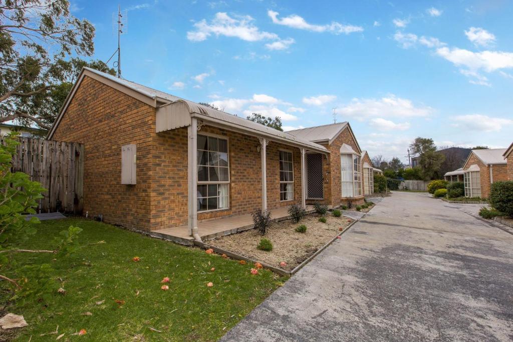 a brick house with a driveway in front of it at Perfect on Pymble Ave in Inverloch