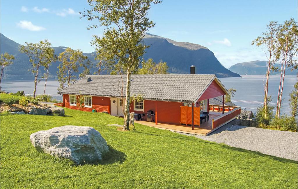 a red cabin with a view of the water at Amazing Home In Hundeidvik With Ethernet Internet in Hundeidvik