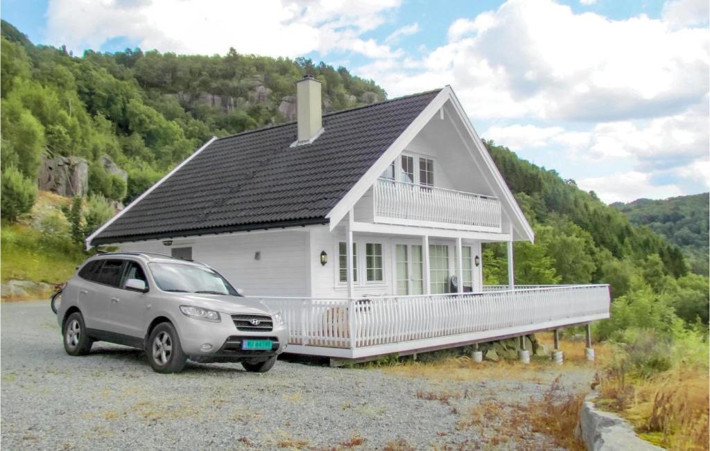 a white house with a car parked in front of it at Beautiful Home In Fister With Wifi in Fister
