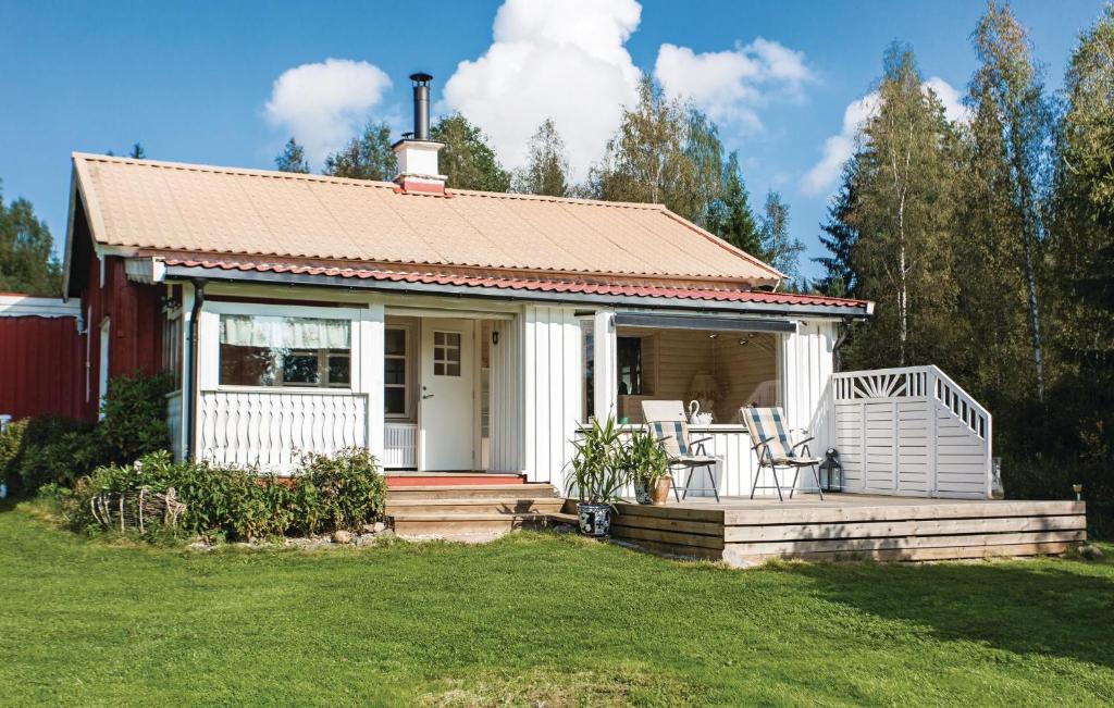 Casa blanca pequeña con porche y sillas en Awesome Home In stra mtevik With Sauna en Östra Ämtervik