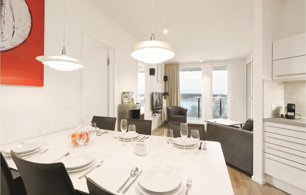 Un comedor con una mesa y sillas blancas. en Highend Travemünde - Whg 302, en Travemünde