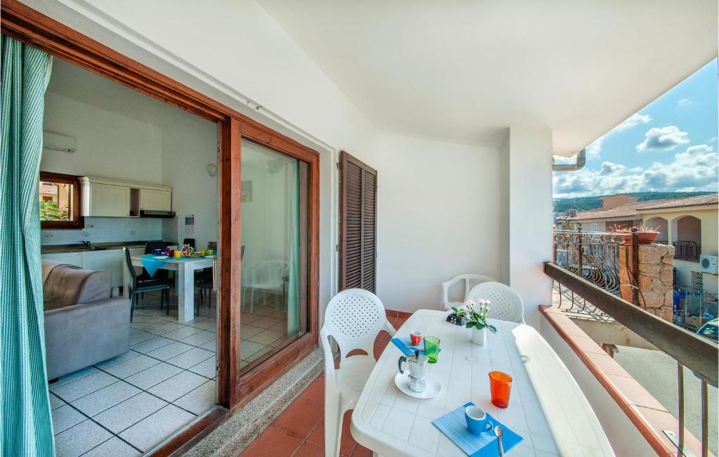 a balcony with a table and chairs and a kitchen at Trilo Sup in Isola Rossa