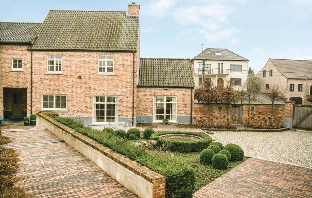 a brick house with a brick walkway in front of it at 4 Bedroom Stunning Home In Borgloon in Borgloon