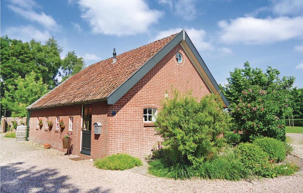 a small red brick building with a black roof at 2 Bedroom Gorgeous Home In Smilde in Smilde