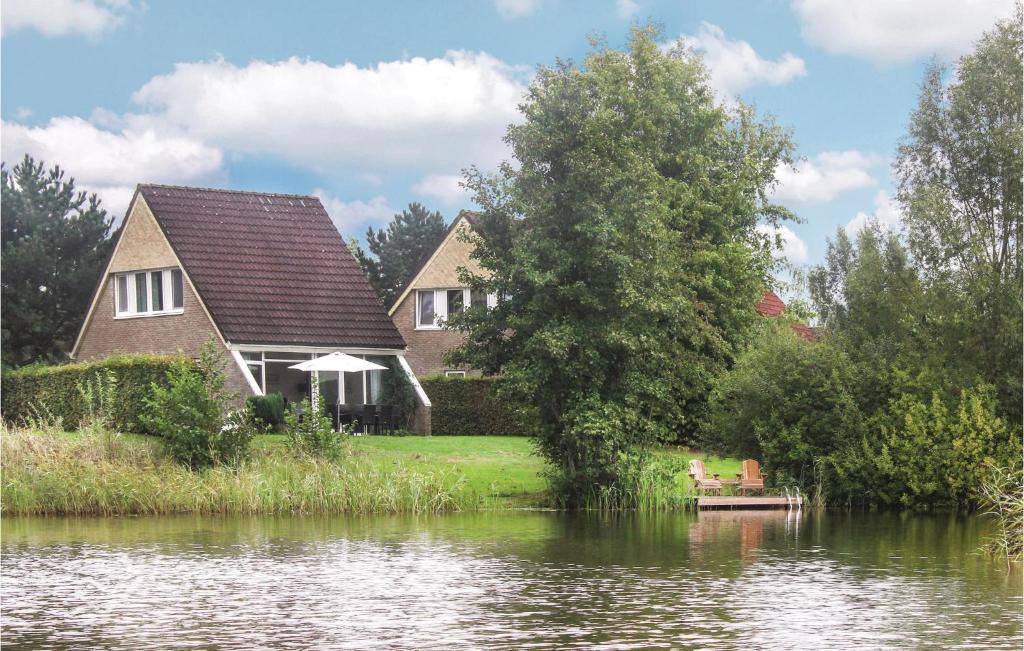 a house next to a river with a house at Awesome Home In Vlagtwedde With Wifi in Vlagtwedde