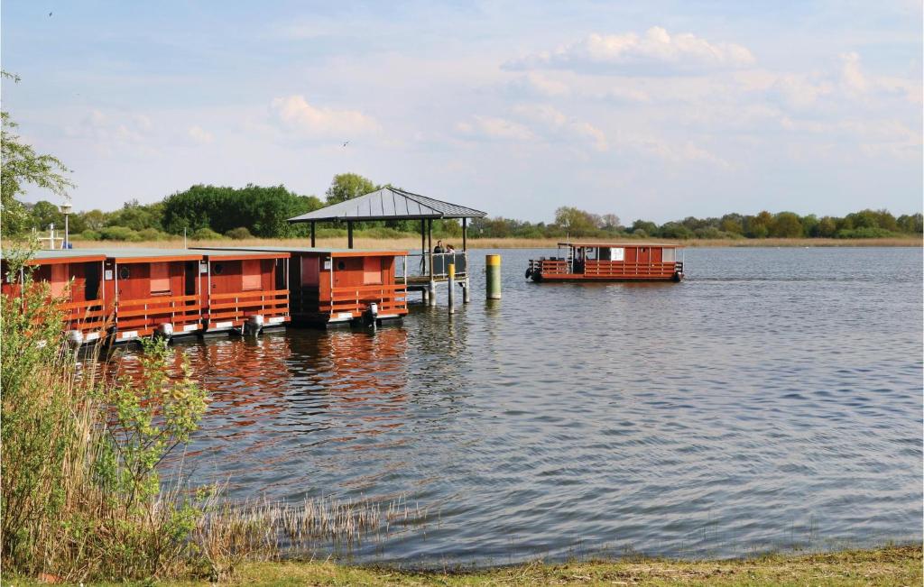 a dock on a body of water with a boat at Stunning Ship In Radewege With Kitchen in Radewege