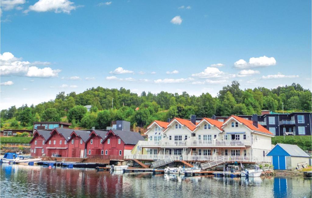 a group of houses and boats on a body of water at Stunning Apartment In Valevg With 2 Bedrooms And Wifi in Valevåg