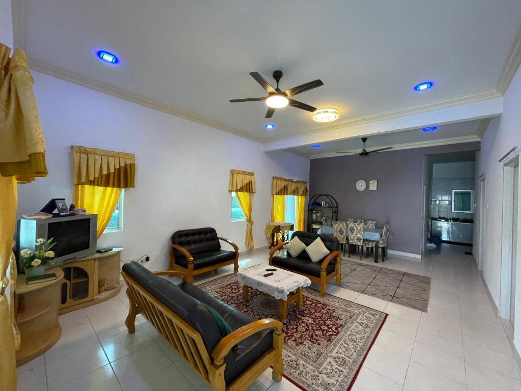a living room with a couch and a table at NORISH HOMESTAY in Bayan Lepas
