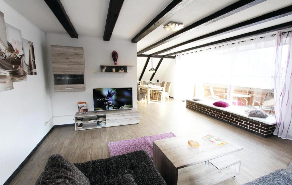 a living room with a couch and a tv at Lovely Apartment In Marienmnster With Sauna in Schieder-Schwalenberg