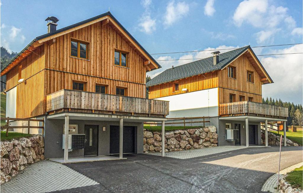una gran casa de madera con una pared de piedra en Lovely Home In Altaussee With Sauna en Hinterposern