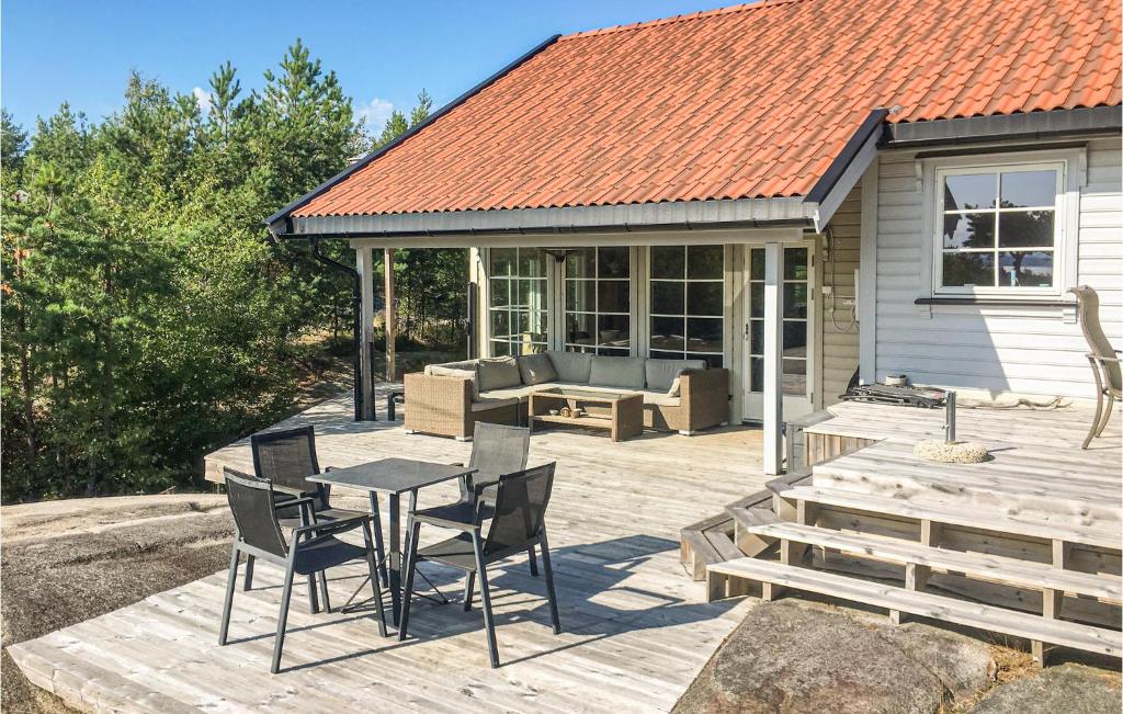 a patio with a table and chairs and a couch at Awesome Home In Skjeberg With 4 Bedrooms in Skjeberg