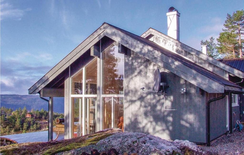 a house with glass doors on the side of it at Lovely Home In Dlemo With Wifi in Øvre Ramse