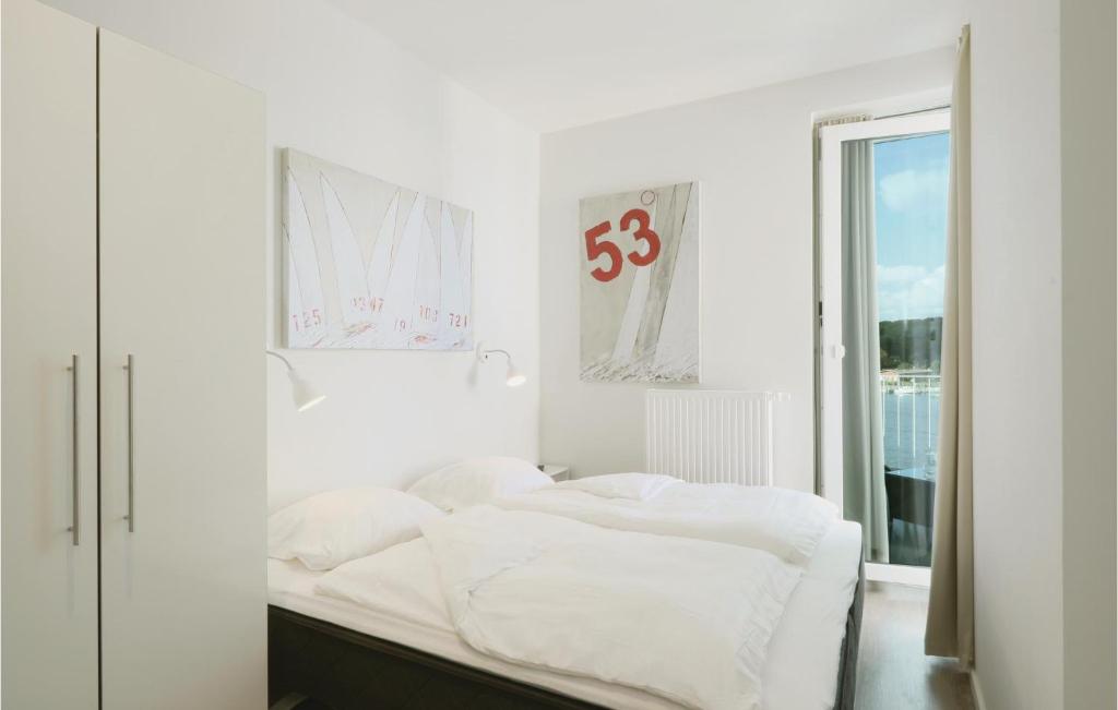 Postel nebo postele na pokoji v ubytování Priwallpromenade 31, Whg 27