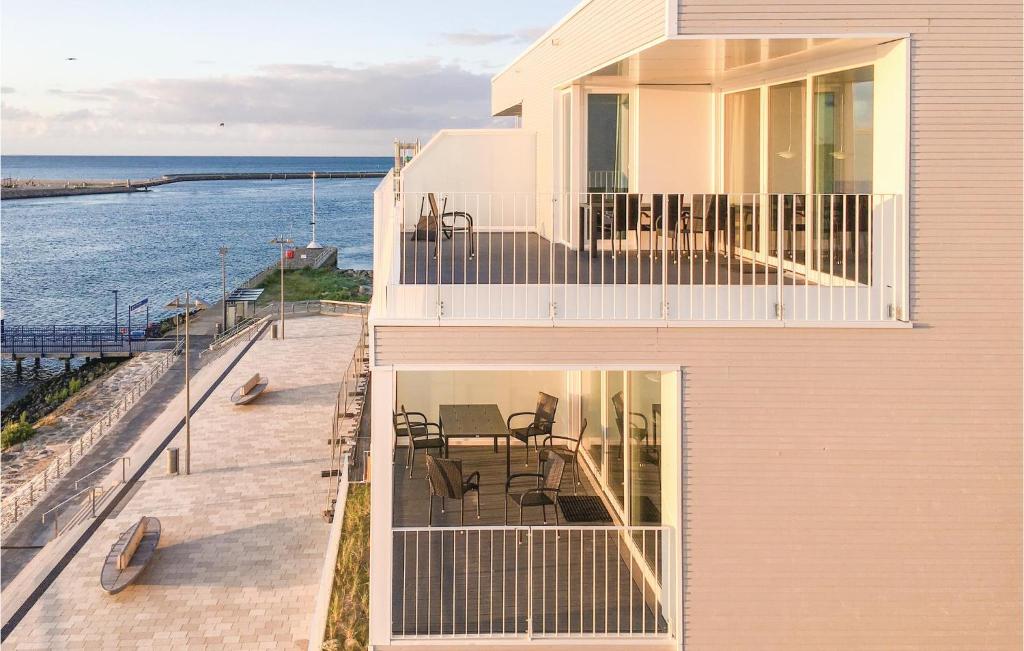 a house with a balcony with a view of the ocean at Promenadenvilla in Travemünde