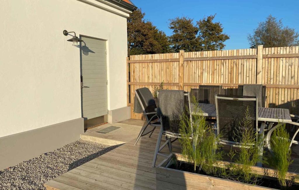 a patio with a table and chairs and a fence at 1 Bedroom Beautiful Apartment In Vellinge in Vellinge