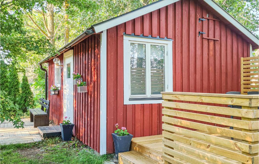 a red cabin with a wooden deck and a window at Awesome Home In Visby With 1 Bedrooms And Wifi in Visby