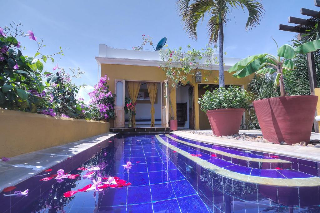 a swimming pool in front of a house at Casa El Carretero Hotel Boutique in Cartagena de Indias