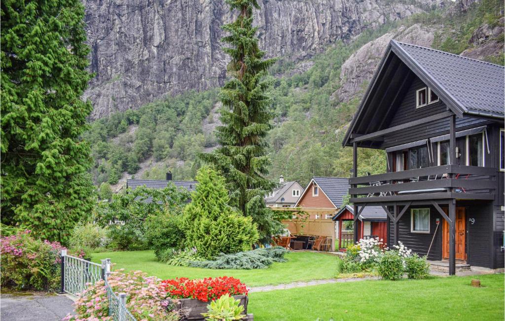 a house with a garden in front of a mountain at 3 Bedroom Lovely Home In Fjra in Fjæra