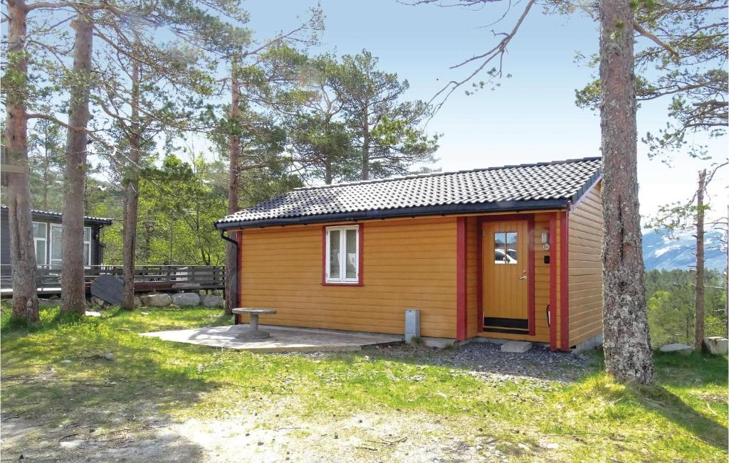 a cabin in the woods with a bench and trees at Beautiful Home In Dirdal With 2 Bedrooms And Internet in Frafjord