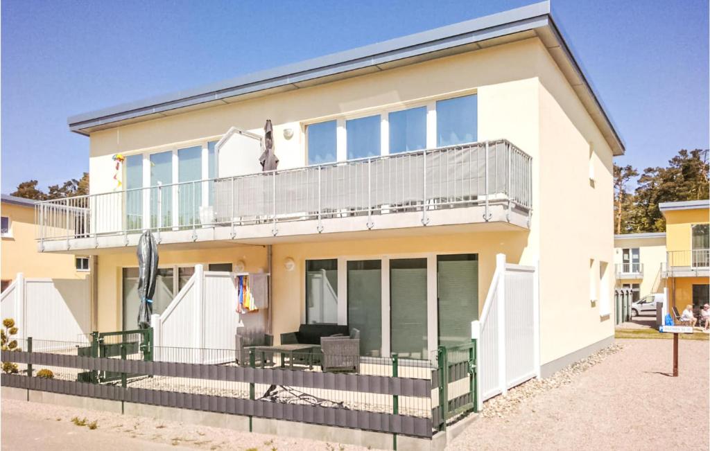 a large white house with a balcony at Beautiful Apartment In Graal-Müritz in Graal-Müritz