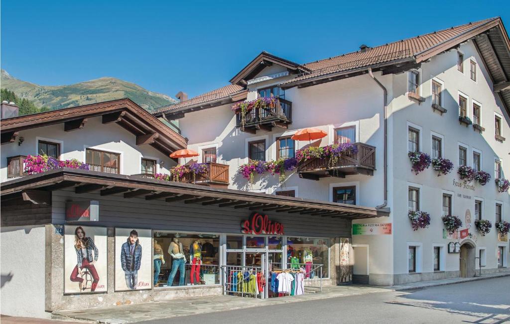 a large white building with balconies and a store at Beautiful Apartment In Rauris With 2 Bedrooms And Wifi in Rauris