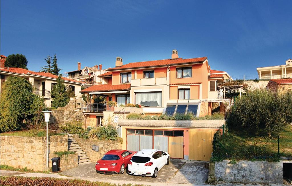 two cars parked in front of a large house at Lovely Apartment In Piran With Kitchen in Piran
