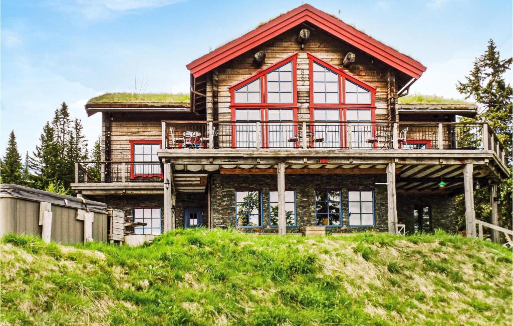 a large log house with a grass roof at Beautiful Home In Trysil With 10 Bedrooms, Sauna And Internet in Mælem