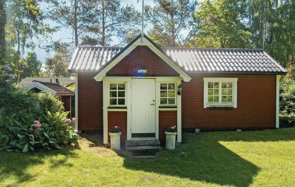 a small red house with a white door at Awesome Home In Ystad With 2 Bedrooms in Ystad