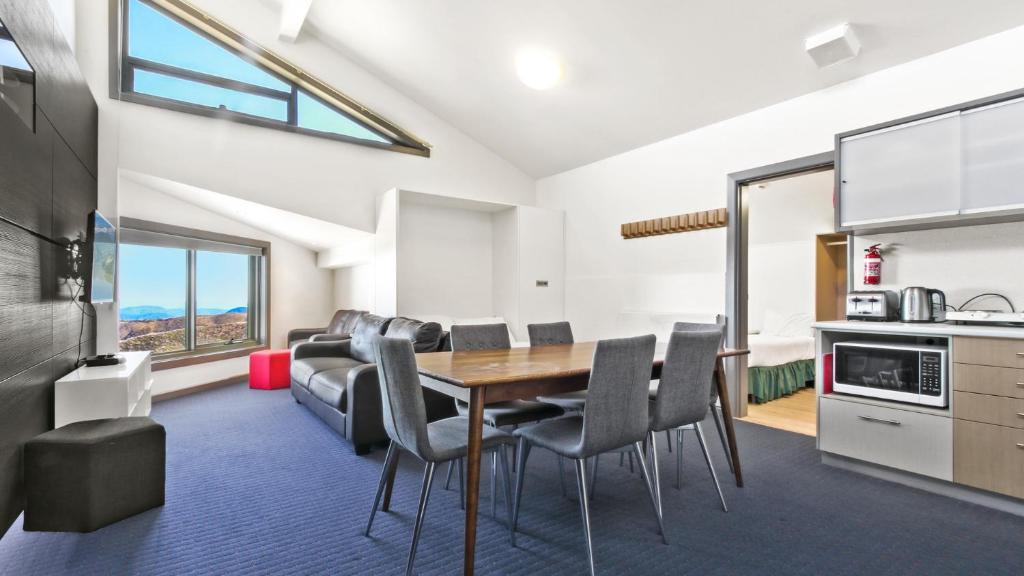a kitchen and dining room with a table and chairs at Alpine Heights 27 in Mount Hotham
