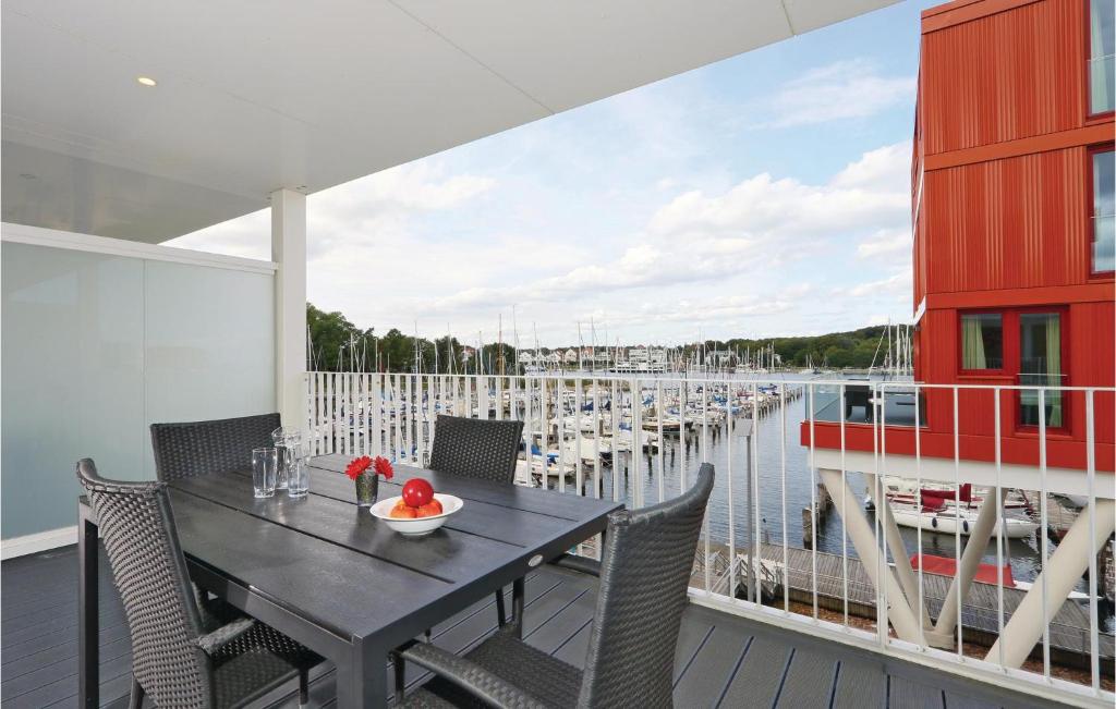 a dining table on a balcony with a view of a marina at Promenadenvilla in Priwall