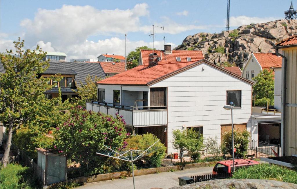 a large white house with a red roof at Amazing Home In Lysekil With 4 Bedrooms, Sauna And Wifi in Lysekil