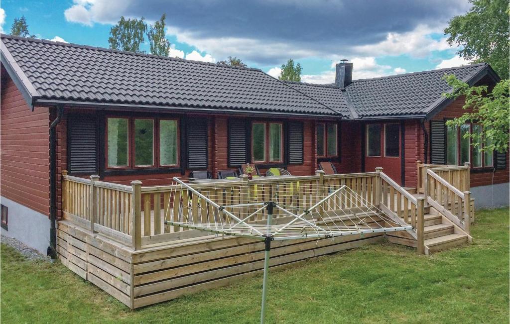 una casa con una gran terraza de madera en el patio en Gorgeous Home In Flen With Sauna en Flen