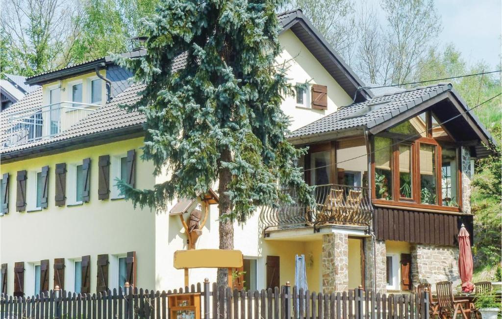 a house with a fence in front of it at Pet Friendly Apartment In Freiberg in Freiberg