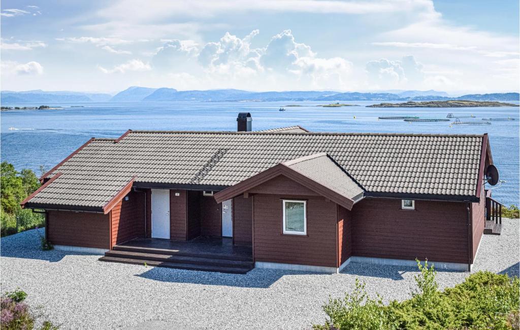 a house with a view of the water at Nice Home In Nedstrand With 5 Bedrooms, Sauna And Wifi in Nedstrand