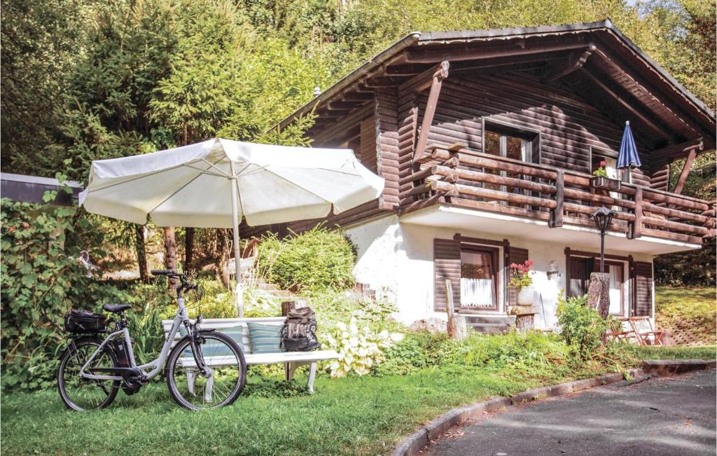 a bike parked next to a bench with an umbrella at Nice Apartment In Schnecken With Wifi in Schönecken