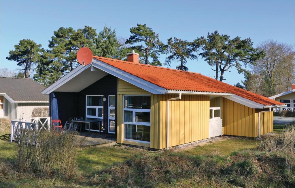 a small yellow house with an orange roof at Frische Brise 20 - Dorf 3 in Priwall