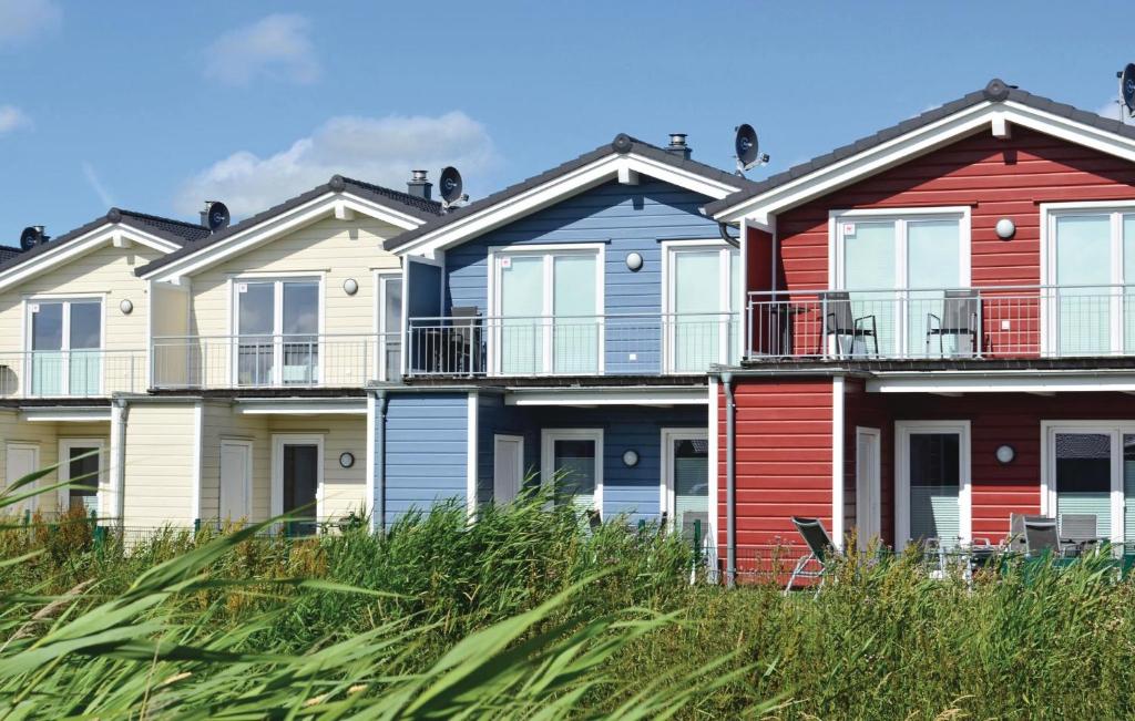 a row of colourful houses on the beach at Gorgeous Home In Dagebll With Wifi in Dagebüll