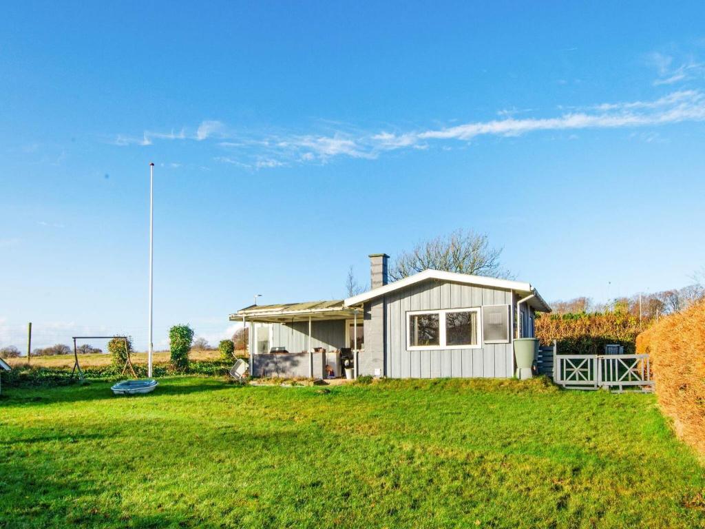 a small house in a field with a yard at Holiday home Haderslev XLV in Haderslev
