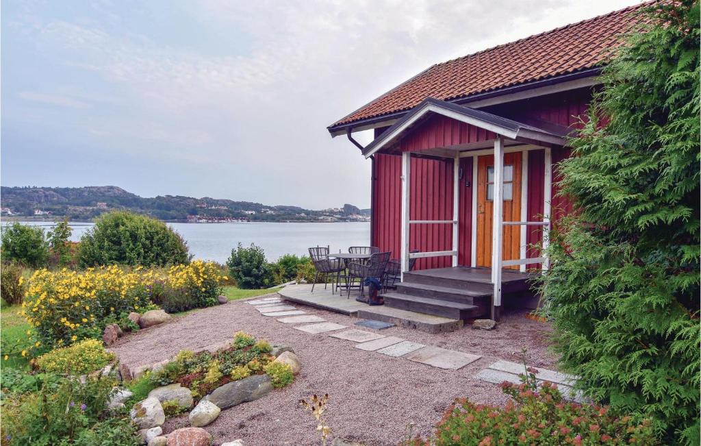 ハンブルクスンドにあるStunning Home In Hamburgsund With 2 Bedrooms And Wifiの赤い家(テーブル、パティオ付)