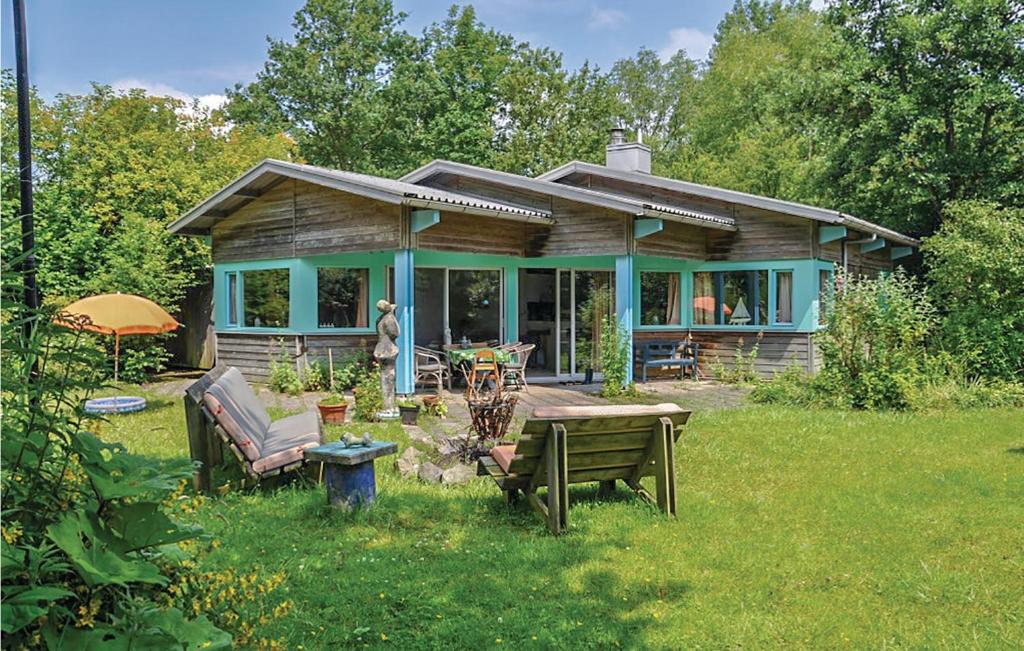 een klein huis met een tafel en stoelen in de tuin bij Amazing Home In Kamperland With Wifi in Kamperland