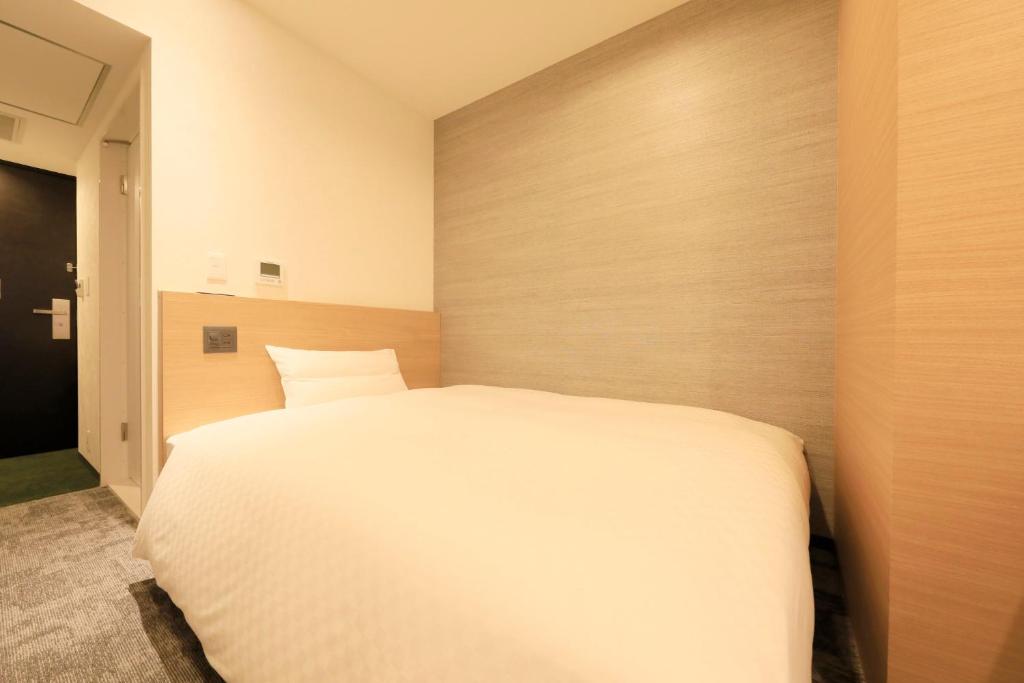 Postel nebo postele na pokoji v ubytování Via Inn Prime Akasaka