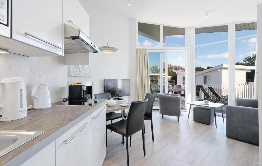 une cuisine et un salon avec une table et des chaises dans l'établissement Dünenvilla 15, Whg 9, à Travemünde