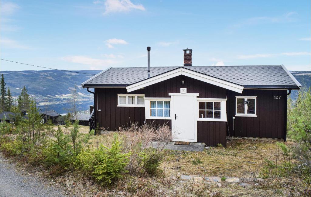 a small black house with a white door at Amazing Home In Fagernes With 2 Bedrooms in Fagernes
