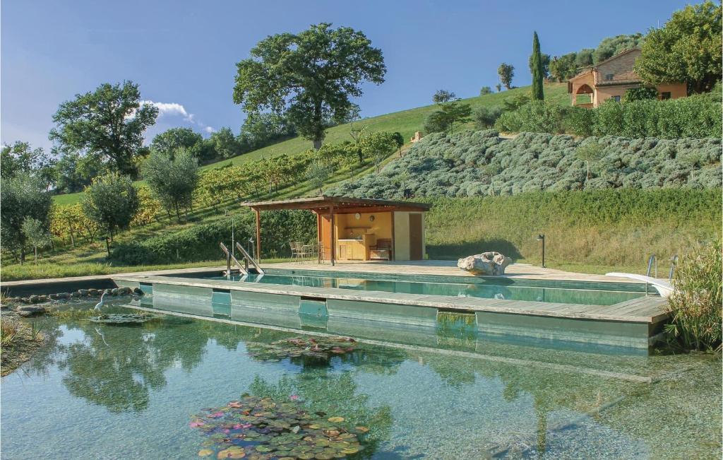 a house with a pool in the middle of a lake at Casa Panorama in Ostra Vetere